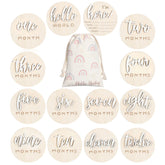 Burbell 7 Pack 3D milestone discs placed in a newborn photo setup, highlighting monthly growth.