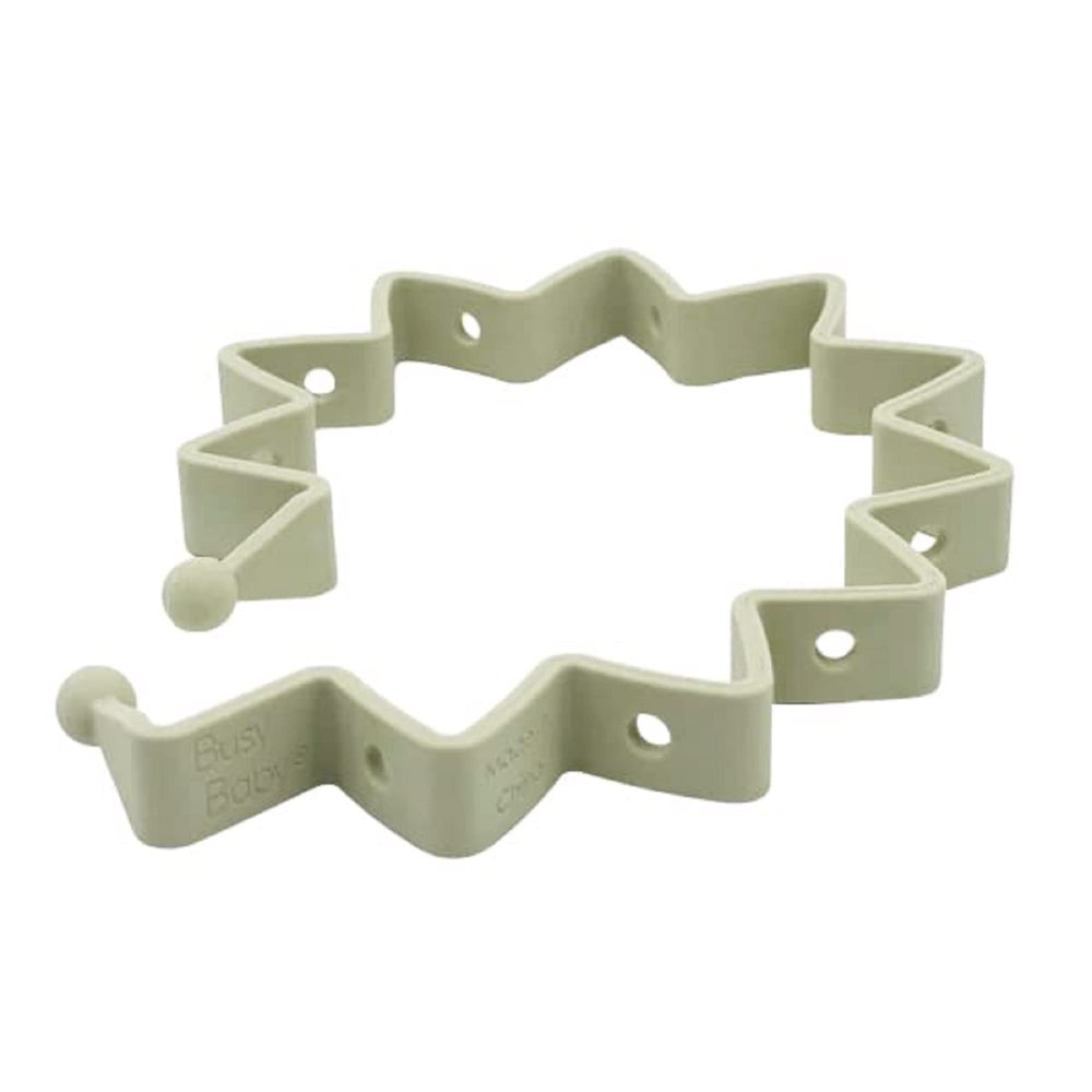 Busy Baby Toy Bungee in tan silicone keeps toys within reach on the mat.