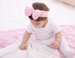 Buttzo baby blanket pink 50x60 being used in stroller for on-the-go warmth.