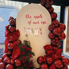 Cantly Apple of Our Eye wall decal creates a festive baby shower backdrop.