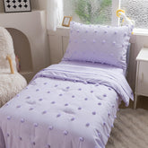 Caressma lavender-pom-pom comforter adds playful texture for cozy nights.
