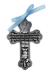 Cathedral Art Baby Boy Cross Crib Medal with blue ribbon beside the crib for nightly blessing.