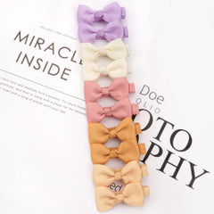 Cellot alligator clip with ribbon secures tiny tresses without slipping.