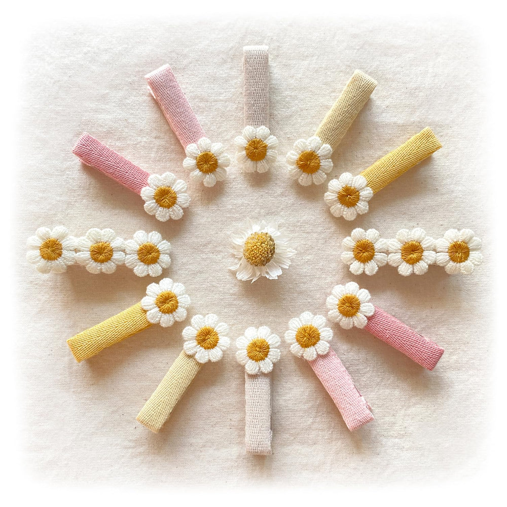 Cherssy daisy clip closeup showing embroidered flower and flat finish for gentle hair