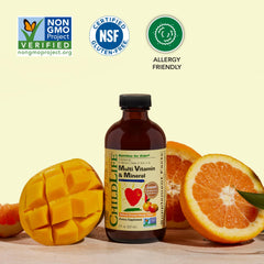 Happy child with CHILDLIFE ESSENTIALS orange mango flavored liquid smile.