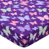 Cloele butterfly-printed crib sheet adds playful color to a gentle girls' nursery.
