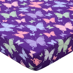 Cloele butterfly-printed crib sheet adds playful color to a gentle girls' nursery.