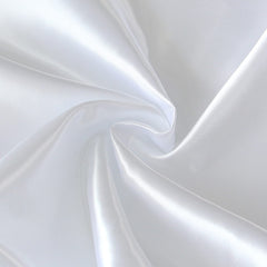 Coldwind satin crib sheet folded neatly, signaling quick setup and hassle-free change.