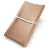 Comfy Cubs muslin changing pad cover on cedar pad, breathable cotton for gentle diaper changes.