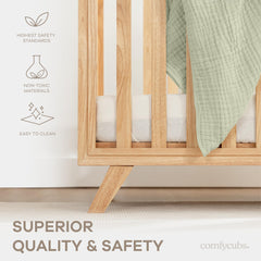 Comfy Cubs natural wood crib finish enhances a calm nursery.