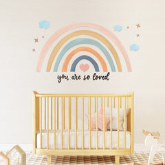 Containlol rainbow wall decal on wall with clouds creates playful decor.