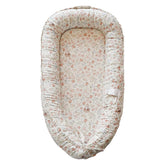 CooCooBaby infant lounger front view with Wonderland Muslin cover for gentle, breathable comfort.