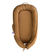 CooCooBaby infant lounger in Golden Brown offers soft support for calming cuddle moments.