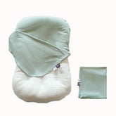 CooCooBaby sage green organic infant lounger cover cradling baby's skin.