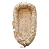 CooCooBaby Poem Muslin infant lounger cover offers breathable comfort for newborn lounging.
