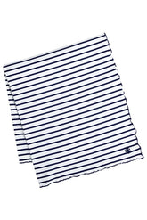 Coolibar Sun Blanket on the beach with UPF 50+ protection for sun safety.