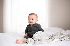 Baby wrapped in Copper Pearl Everest swaddle during nap time