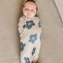 Copper Pearl Gemma Tan swaddle blanket wrapping a baby for cozy comfort