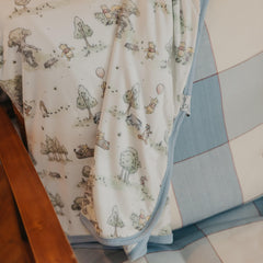 Copper Pearl Hundred Acre Wood quilt folded, ready for nursery storage or gifting