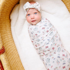 Copper Pearl Minnie Bowquet swaddled baby demonstrating cozy wrap