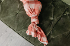 Copper Pearl Ralphie swaddle on display by model highlighting versatile design.