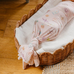 Copper Pearl swaddle used as a baby playmat during tummy time