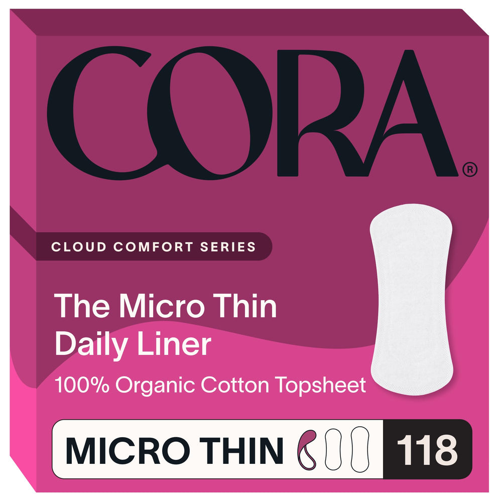 Cora topsheet organic cotton liner on soft surface, highlighting natural texture and skin-friendly feel.