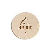 The Cotton & Canvas Co. He's Here newborn disc used as a rustic photo prop.
