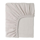 Cottonsis Muslin crib sheet close-up shows ultra-soft fabric for newborn comfort.