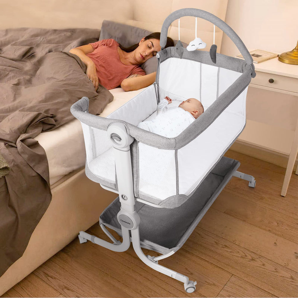 Cowiewie baby bassinet bedside sleeper with storage basket and wheels for bedside convenience.