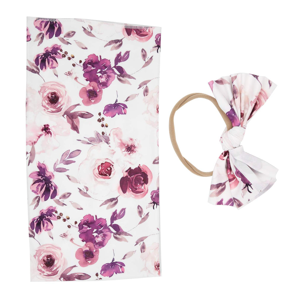 Crisis receiving blanket with deep purple flower design offers cozy warmth for newborns.