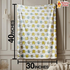 Cudlie Winnie the Pooh blanket multicolor design laid out as nursery decor and cuddles.