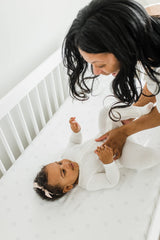 CutieCozy satin crib sheet close-up shows a smooth, durable weave.