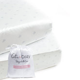 CutieCozy satin fitted crib sheet in white with gray hearts and stars protects delicate baby curls.