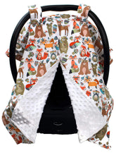 Dear Baby Gear Deluxe car seat canopy with tribal woodland animals shields baby from sun and wind.