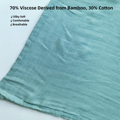 DEZIGKA sage green swaddle used as nursing cover for discreet breastfeeding.
