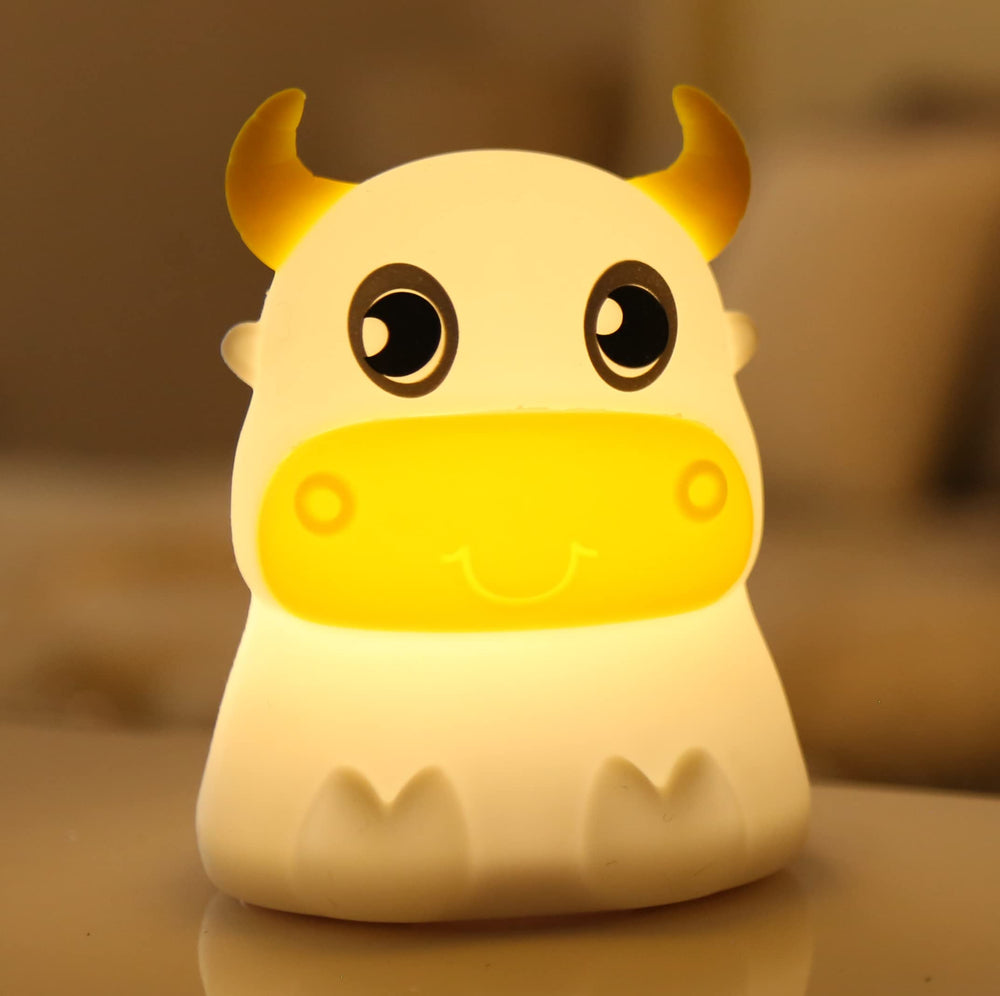 Dimanito cow night light, front view provides gentle illumination for bedtime routines.
