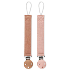 Dirbabi pacifier clip with soft cotton caramel and pink fabric on baby outfit
