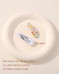 Doboi navy pink cloth snap clip secures toddler hair without fuss.