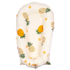 DockATot Deluxe Lounger Cover in pineapples print offers breathable, hypoallergenic protection.