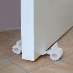Dreambaby Under Door Gripper on cork flooring reduces finger pinch risk.
