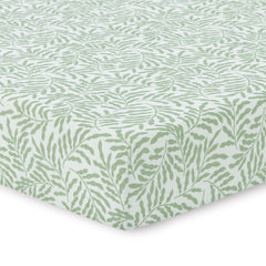 Dreamology leaves crib sheet on a crib showing cozy breathable muslin fabric