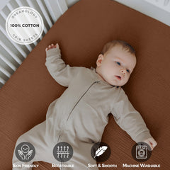 Dreamology muslin crib sheet close-up shows elastic edge for secure fit.