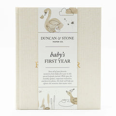 Duncan Stone Paper Co. Baby First Year Book cover in cream linen with gold foil, timeless keepsake.