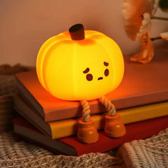 Front view of the Dylviw Pumpkin Night Light glowing softly for cozy nights