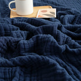 EMME muslin baby blanket navy folded, showing soft fabric and breathable weave