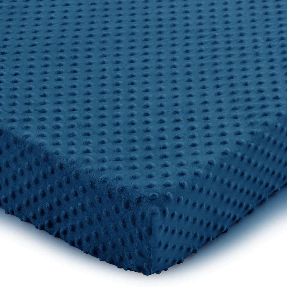 Entisn navy blue crib sheets on a standard mattress for a cozy sleep setup