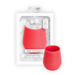 ezpz Tiny Cup Coral held by tiny hands showing handheld fit and comfort.