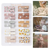 Fancy Clouds rose-pattern fabric alligator clip provides secure hold for fine hair.