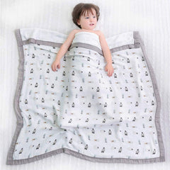 Farmer Mani swaddle gray nursing cover for on-the-go feeds.
